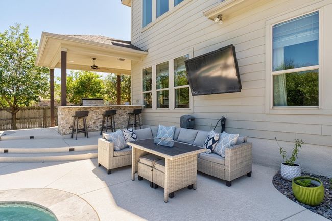 View of patio featuring outdoor lounge area, fence, and ceiling fan | Image 36