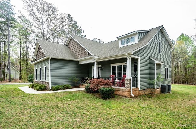 Craftsman-style home featuring covered porch, a shingled roof, and a front lawn | Image 4