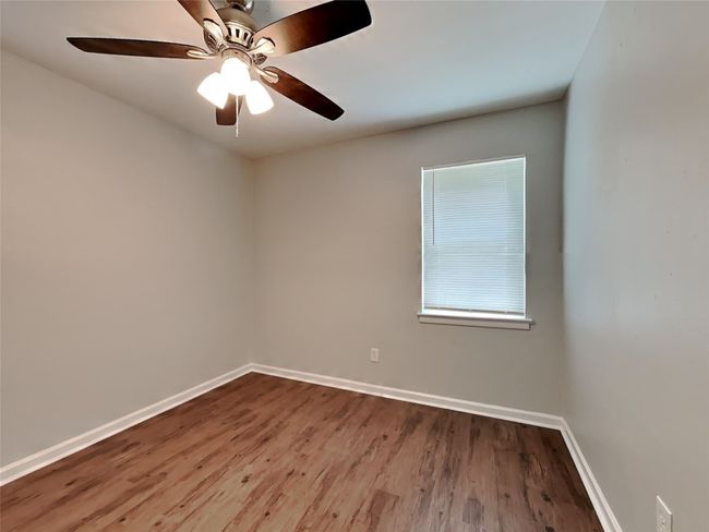 Unfurnished room with wood finished floors and a ceiling fan | Image 7