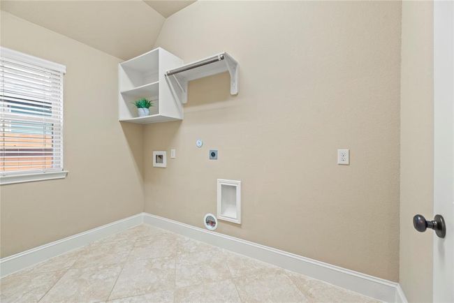 The generously sized utility room provides both electric and gas dryer connections. | Image 22