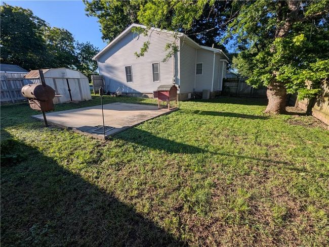View of yard featuring a patio and central air condition unit | Image 8