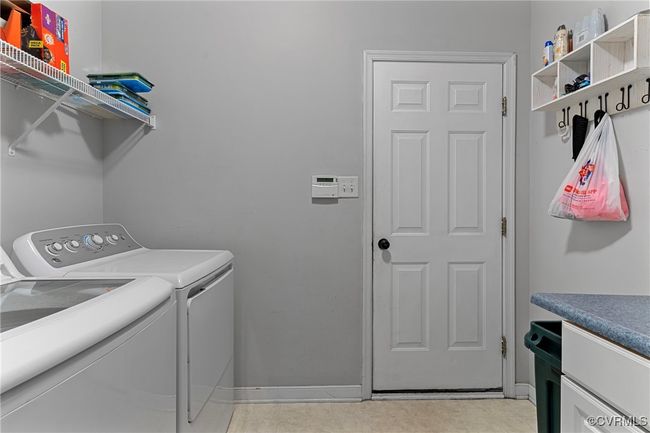 Laundry area with washing machine and dryer, laundry area, and baseboards | Image 41
