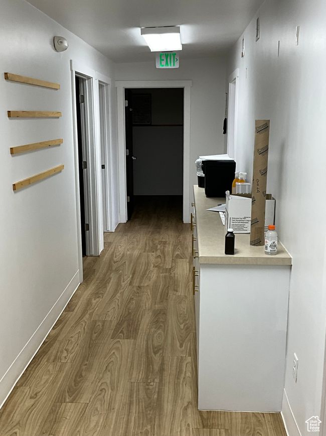 Hallway with baseboards and wood finished floors | Image 28
