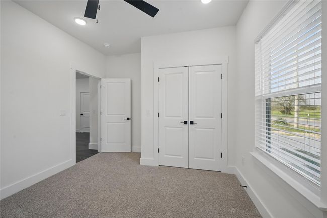 Unfurnished bedroom featuring baseboards, a ceiling fan, a closet, and carpet | Image 19