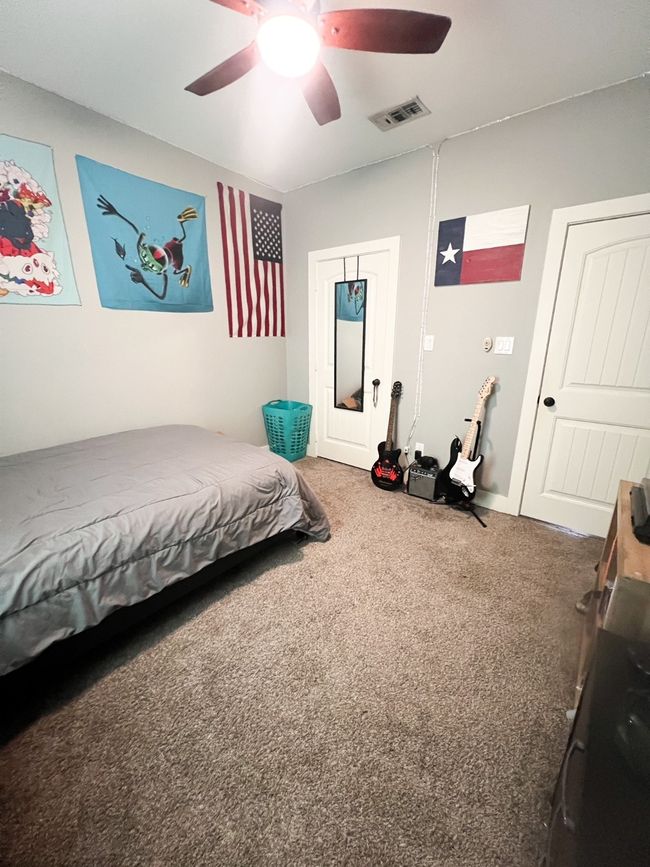 Bedroom featuring ceiling fan and carpet floors | Image 19