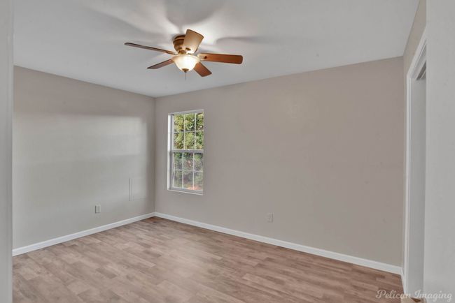 Unfurnished room featuring ceiling fan and light hardwood / wood-style floors | Image 12