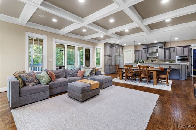 Living area featuring coffered ceiling, dark wood-type flooring, plenty of natural light, beam ceiling, and recessed lighting | Image 19