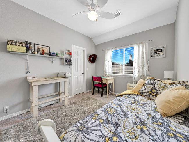 Bedroom featuring carpet floors, lofted ceiling, visible vents, and baseboards | Image 34