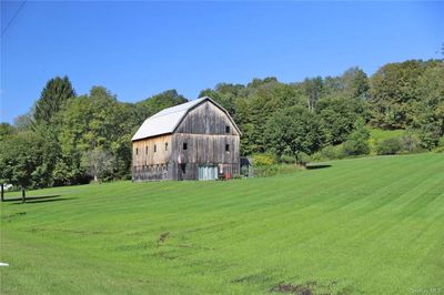 View of outdoor structure featuring a lawn | Image 1