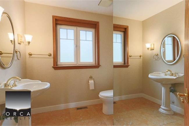 Bathroom with a sink and tile patterned floors | Image 16