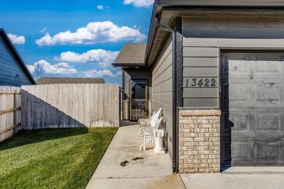 View of property exterior featuring a yard and a garage | Image 2