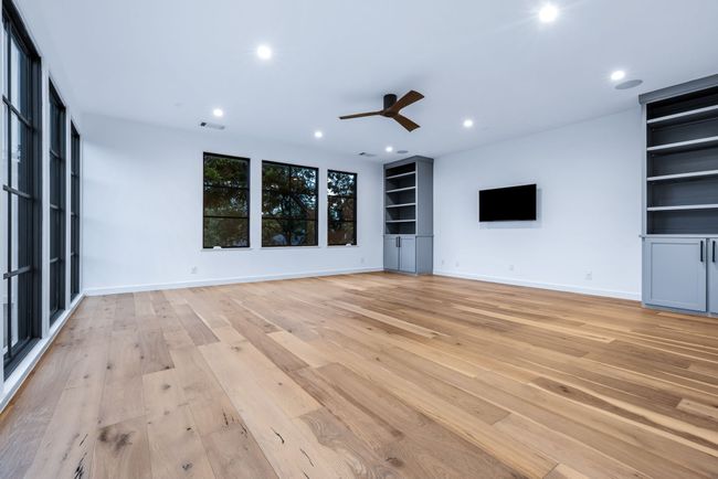 Unfurnished living room with ceiling fan, light wood-style floors, and recessed lighting | Image 25