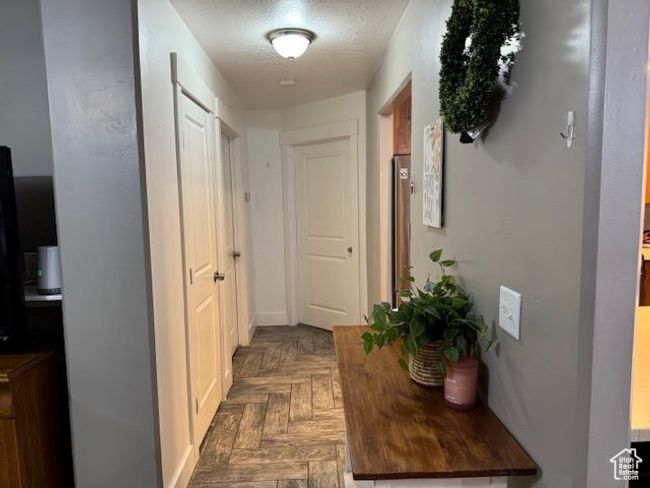 Hallway featuring a textured ceiling | Image 11