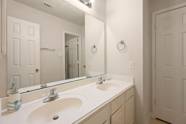 Your upstairs full bath features double sinks. | Image 21