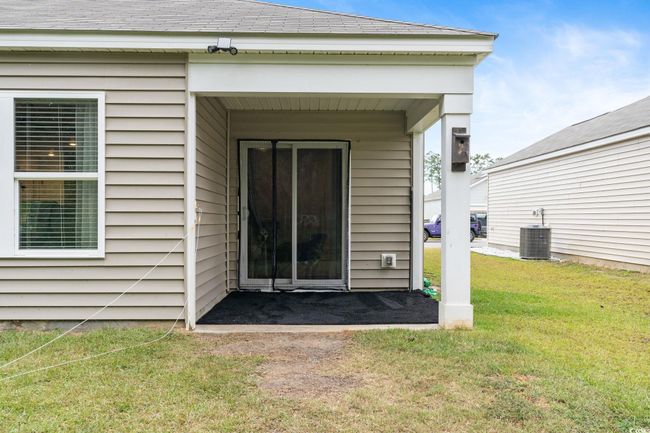 Entrance to property with central AC and a lawn | Image 31