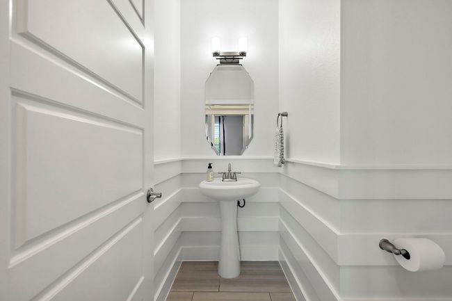 Bathroom with a sink and wood finished floors | Image 16