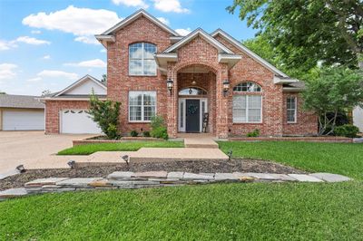 Front facade with a garage and a front lawn | Image 1