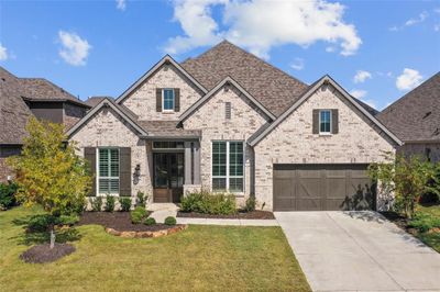 View of front of house with a garage and a front lawn | Image 1