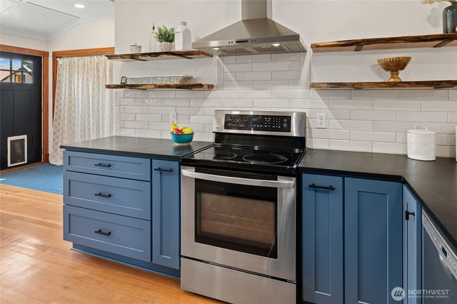 Custom shelves and subway tile infuse the kitchen with a fresh, curated feel. | Image 14