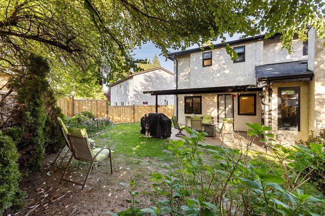 Rear view of home with a fenced backyard, and a patio area | Image 29