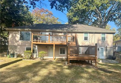 Rear view of property featuring a wooden deck and a lawn | Image 3