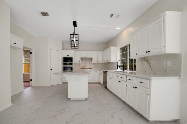 Chef style Kitchen featuring stainless steel appliances, decorative backsplash, a deep sink, and recessed lighting | Image 8