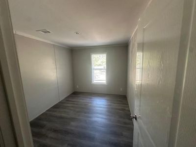 Living room with beamed ceiling, wood-type flooring, and ceiling fan | Image 2