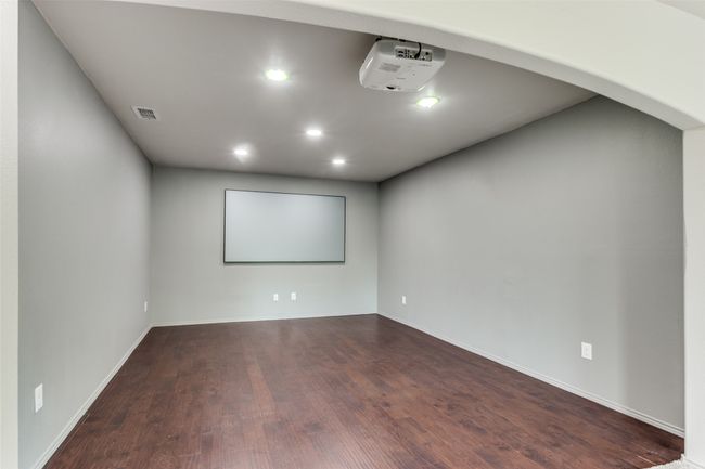 Home theater featuring dark wood-type flooring and recessed lighting | Image 32