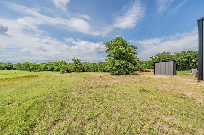 View of yard featuring a view of rural / pastoral area and an outdoor structure | Image 11