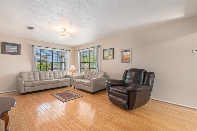 Living room with wood floors and natural light | Image 6