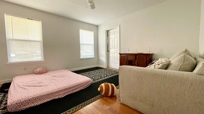 Bedroom with wood finished floors and ceiling fan | Image 15