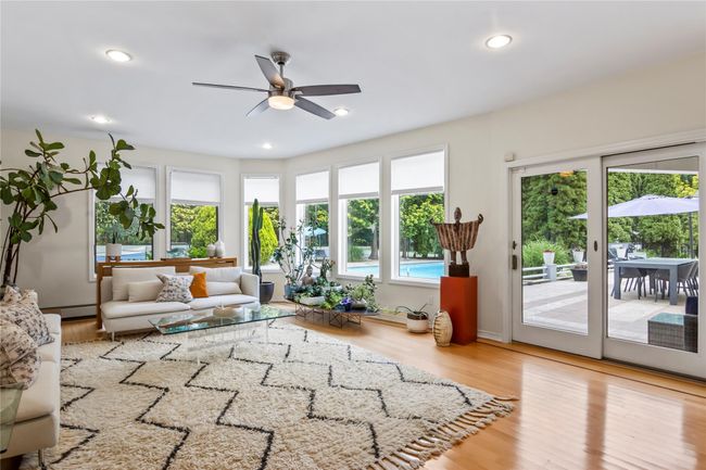 Living room with ceiling fan, wood finished floors, and recessed lighting | Image 15