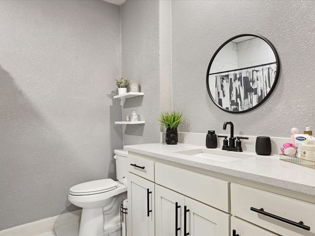 Full bath with vanity, toilet, a textured wall, and tile patterned flooring | Image 24