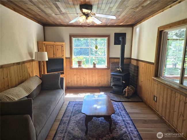Living room has lots of windows, bringing in extra light. Notice the great custom woodwork. | Image 5