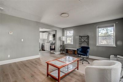 Living room featuring a healthy amount of sunlight, sink, and light wood-type flooring | Image 3