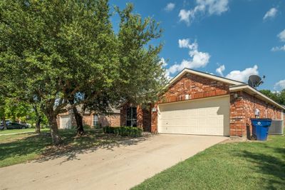 View of front of house with a garage, central AC, and a front yard | Image 1