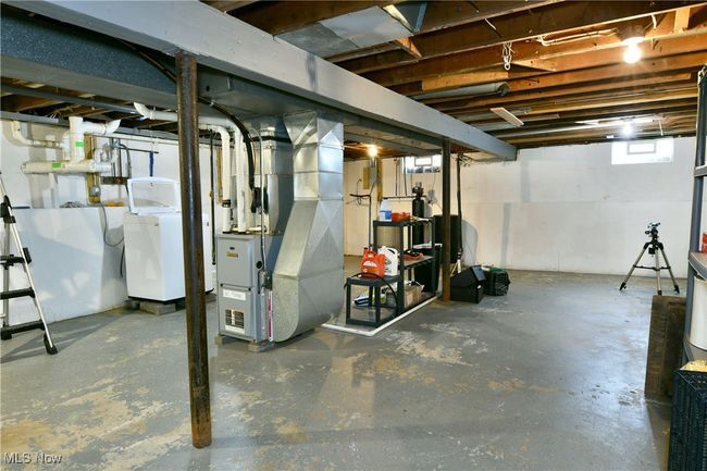 Basement featuring washer / clothes dryer and heating unit | Image 36