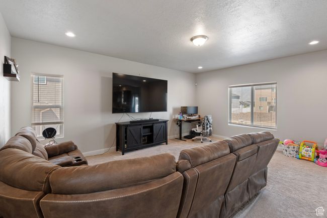Living room featuring light carpet, a healthy amount of sunlight, and baseboards | Image 7