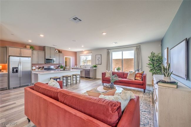 Living room with light wood-type flooring and recessed lighting. Photo is representational only; actual home finishes may vary. | Image 9