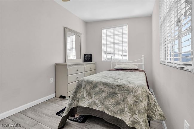 Bedroom featuring light baseboards, and multiple windows | Image 14
