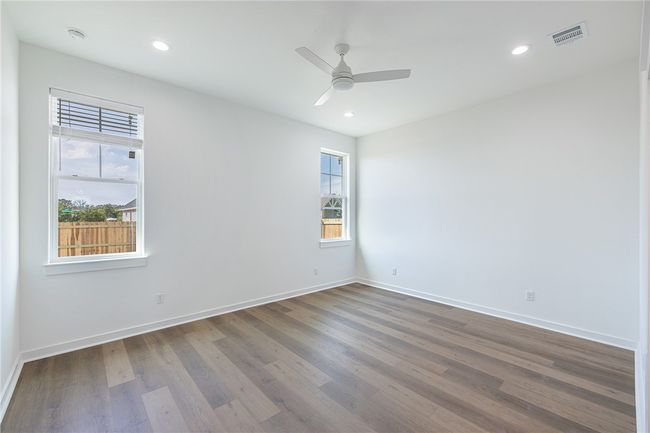 Unfurnished room featuring a wealth of natural light, hardwood / wood-style floors, and ceiling fan | Image 14