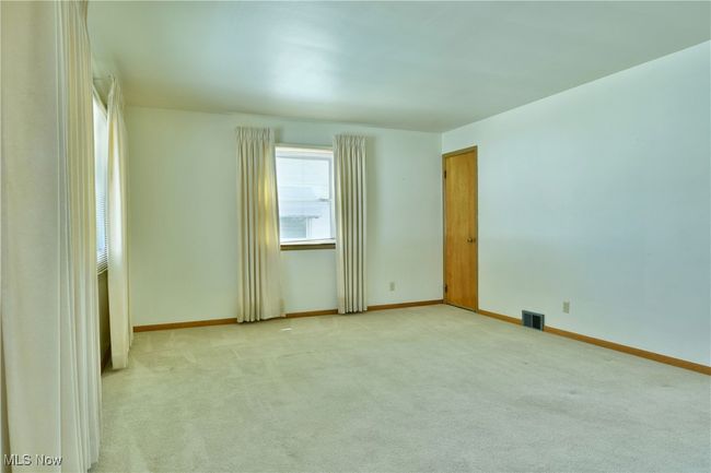 Unfurnished room featuring baseboards, visible vents, and light colored carpet | Image 12