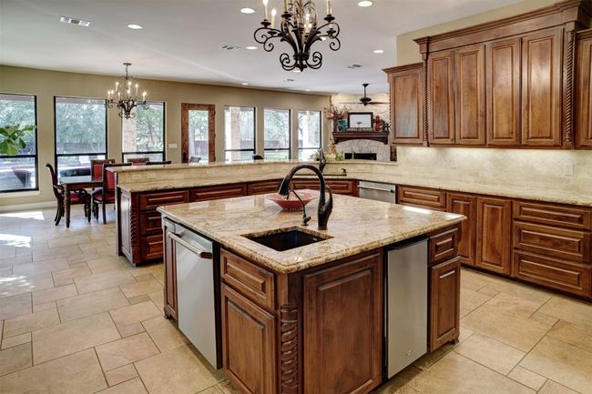 Kitchen boasts high end appliances with 48" Thermador duel fuel range with gas cooktop and griddle. Range has two electric ovens. There is an additional built-in wall Thermador oven. Two dishwashers. Built-In Microwave. Built-In Refrigerator/Freezer. Ice Maker. Two sinks. Pot filler over range. Gorgeous center island. And the Counter space is endless. | Image 4