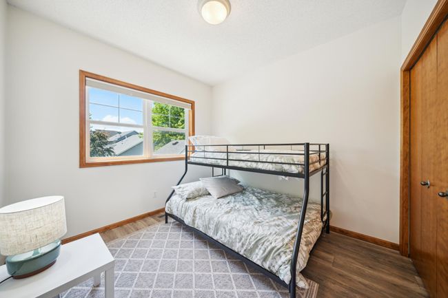 Upstairs are three bedrooms, including a spacious primary suite and laundry. | Image 26