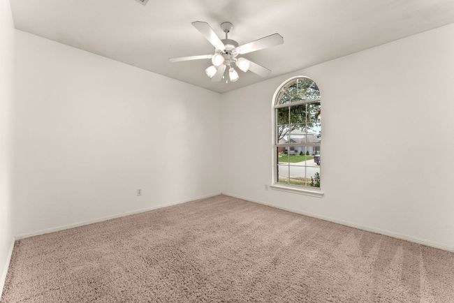 Unfurnished room featuring carpet floors, baseboards, and a ceiling fan | Image 24