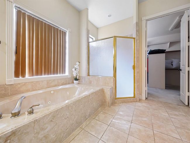Luxurious master bathroom featuring a spacious brand new walk in shower, separate soaking tub, and elegant double sinks. | Image 28
