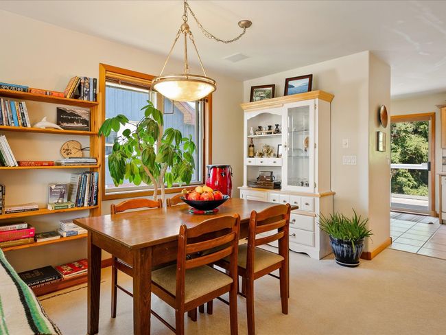 Dining space featuring visible vents and light colored carpet | Image 7