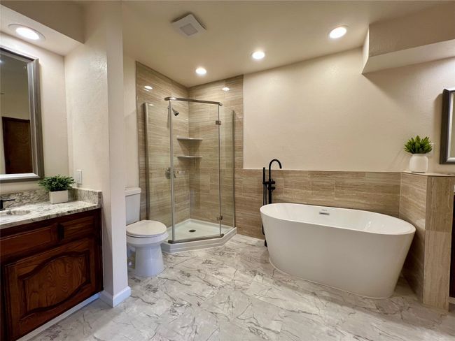 Bathroom featuring a soaking tub, vanity, a stall shower, recessed lighting, and marble finish floors | Image 12