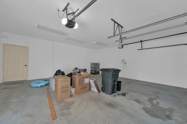 Garage with trash in the photo. The trash is no longer there. Quite Room / Office / Exercise Room through the door on the left. | Image 34