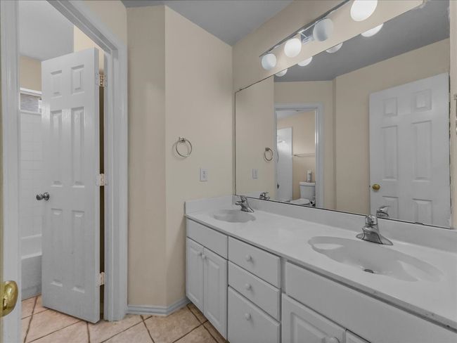 Full bathroom featuring double vanity and tile patterned flooring | Image 20